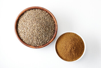 Indian seeds or spices called cumin seed and cumin powder in bowl isolated on white background 