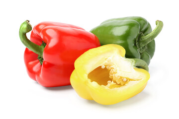 yellow bell pepper halved with a red bell pepper and a green bell pepper placed behind it. isolated on white background.