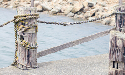 Rope Tied to a Bollard on the Pier Beside the Pacific Ocean