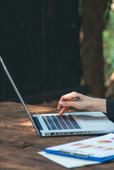 Vertical Horizon Asian Woman using laptop working from home online meeting in home office. Vertical...
