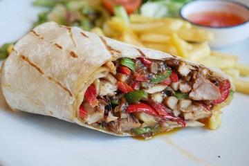 Delicious burrito filled with grilled chicken and vegetables