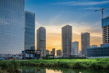 Captivating Urban Sunset Over Skyscrapers Reflected in Tranquil Waters