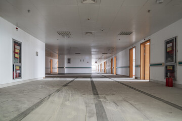 Empty Hallway with Open Doors: An Eerie Glimpse into Abandonment