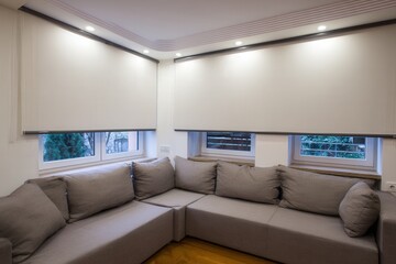 Bright modern living room featuring wireless solar charging windows and integrated eco friendly LED lighting, calm neutral palette.