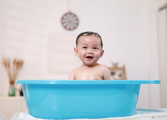 Baby's morning routine, cleaning baby and infant in the bath, hygiene, health or wellness with mother at home