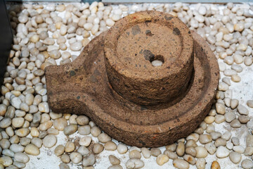 Ancient Stone Artifact Resting Among Smooth Pebbles in Tranquil Setting