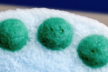 Macro shot of an artistic dish styled to resemble bacteria or virus cells, plated with fine-dining elegance on a minimalist table in soft lighting.