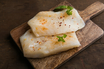 Fresh Cod Fillet on Wooden Board