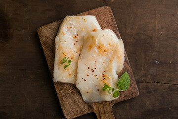 Fresh Cod Fillet on Wooden Board