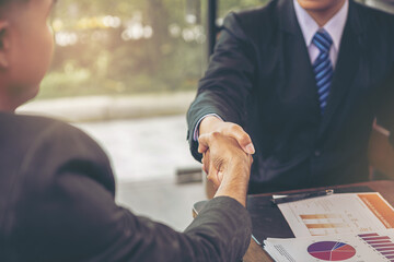 Businessman handshake at business meeting after negotiations with business partners. Selected focus