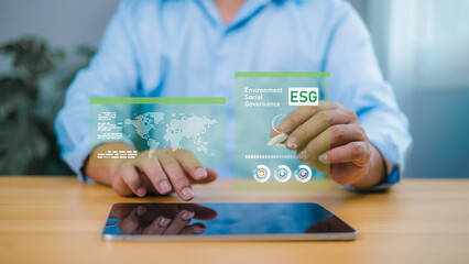 Person using holographic display with global map and ESG text, symbolizing environmental...