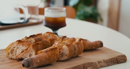 Pieces of bread on a wooden board. breakfast with croissant and coffee