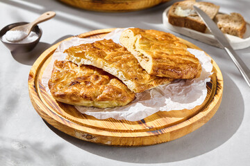 Chicken pie rustic bright overhead with golden crust and layered filling on wooden plate