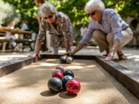 active seniors playing pã©tanque in park