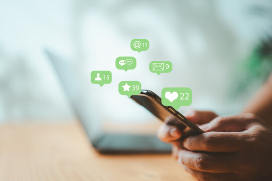 Businessman using smartphone with social media icons for business communication