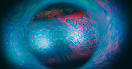 Defocused gasoline fluid. Mystical paint. Colorful glowing emulsion oil mix sphere. Blue green...