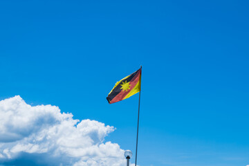 Sarawak flag waving against blue sky, flag of the Sarawak state, East Malaysia