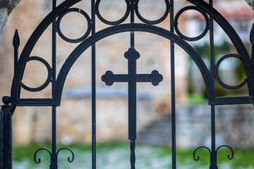 Old church gate with a Christianity cross. 