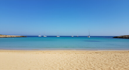 Scenic view of turquoise waters and sailing boats at Konnos Beach, Cyprus