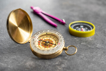 Closeup view of navigational compass and pink compasses on a black background. Travel guidance...