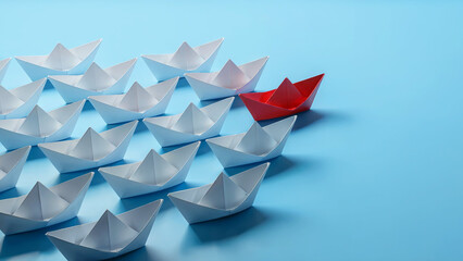 A single red paper boat leads a fleet of white paper boats on a bright blue background symbolizing leadership and uniqueness