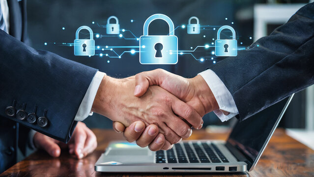 Two businessmen shaking hands over a laptop with a digital network of glowing security locks symbolizing data protection and cybersecurity