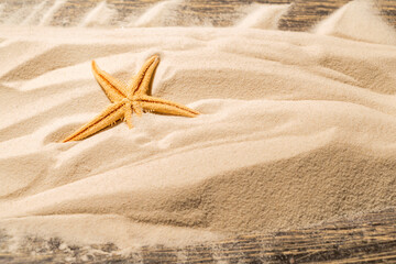 Starfish on the sand with a wooden background. Beach scene. Summer concept © Leo Lintang