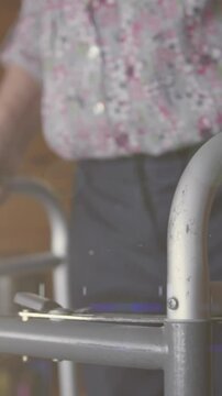 Animation of glowing light over senior man with walking frame