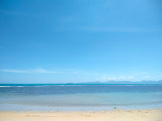Scenic Sandy Beach with Blue Sky and White Clouds at Nathon Beach, Koh Samui, Thailand