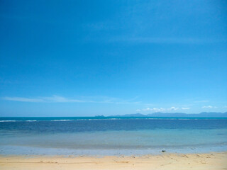 Scenic Sandy Beach with Blue Sky and White Clouds at Nathon Beach, Koh Samui, Thailand