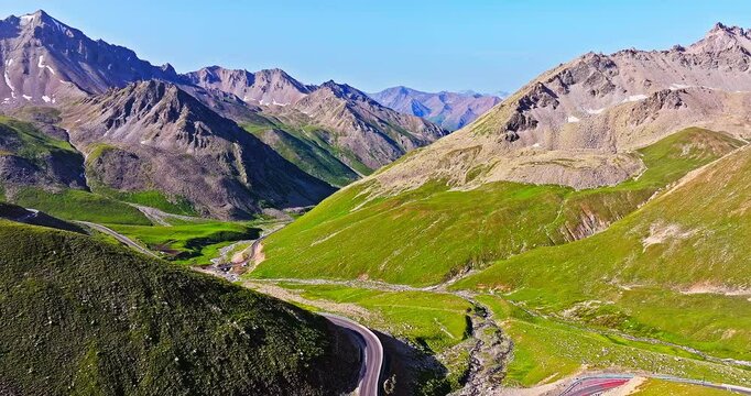 Asphalt highway road in the valley. Spectacular Duku highway and mountain natural landscape in Xinjiang. Duku highway is the most beautiful highway in China.