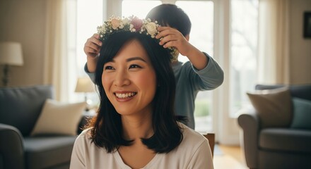 Son placing a floral crown on his smiling mother, joyful moment.