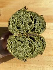 Matcha sourdough sliced open, revealing airy crumb.