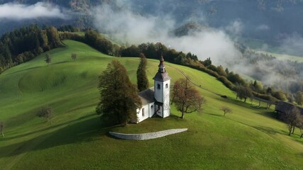 St. Thomas Church Nestled In The Hills Near The Town Of Skofja Loka In Slovenia - Drone Shot