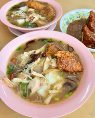 Chicken noodle soup with fried dumpling topping.