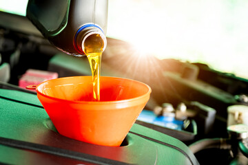 Refueling and pouring oil quality into the engine motor car Transmission and Maintenance Gear...