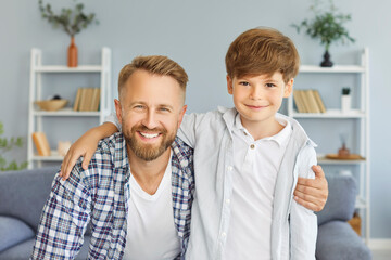 Portrait of a happy son and father at home during Father Day. The family celebrates the special...