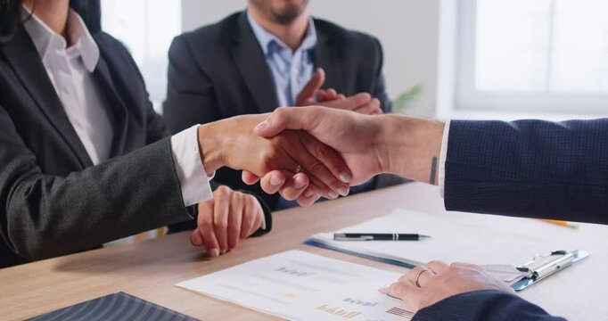 Banker clients successful handshake loan ownership signing rental contract at meeting with realtor or landlord, first property purchase, mortgage, rent document signature assistance in office