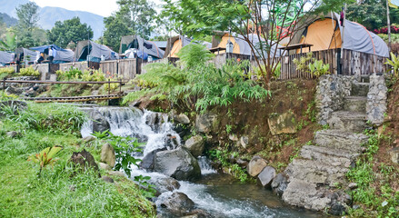 tropical riverside camping view, puncak mas, west java, indonesia

