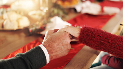 People, holding hands or thanksgiving with dinner for meal, event or Christmas feast together. Closeup, family or praying with faith at dining table for praise, December tradition or new year in home