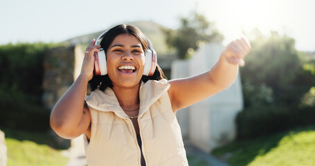 Fashion, headphones and happy woman dance outdoor with energy, freedom and celebration. Listening...