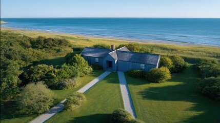 Top-down drone capture of Cape Cod cottage with symmetrical lawn path late afternoon shadows stretch horizon sand tones