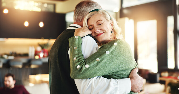 Hug, couple or dancing in home for Christmas, love or romance in relationship or embrace. Happy woman, festive season or senior people bonding in lounge for xmas holiday, marriage or support in house