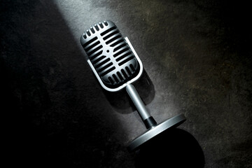 Vintage silver microphone with a black background. Top view