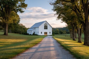 White metal barn with glass front gable sidelight bouncing off gravel driveway casting crisp shadows cinematic field depth