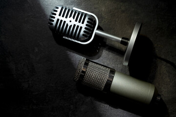 Studio and vintage silver microphone for podcasting or streaming with a black background. Top view
