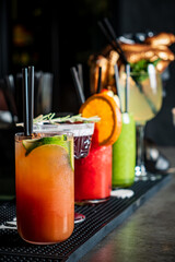 Colorful cocktails with fresh garnishes invite patrons to enjoy a lively night out at the bar