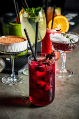 Vibrant cocktails in elegant glasses showcase the creativity of mixology at a busy bar