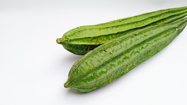 Raw Chinese Okra (Luffa)  or Sin Qua or Ridge Gourd Vegetable or Gambas or Oyong on white background. Authentic Asian vegetable ingredient