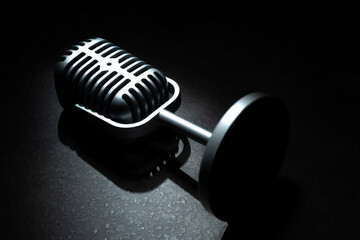 Vintage silver microphone with a black background